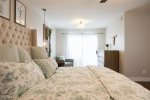 Master bedroom suite w/ king size bed and private backyard access